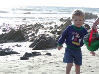 Timothy examines a bucket full of rocks