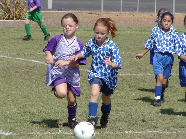 Natalie and a Dolphin battle for the ball