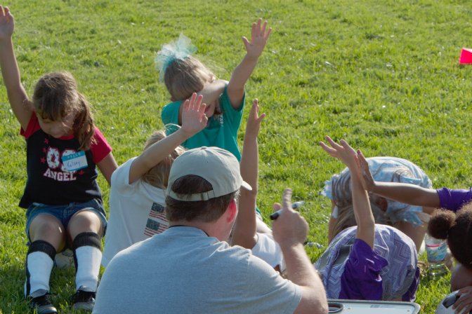 Heads down, eyes closed, and hands in the air