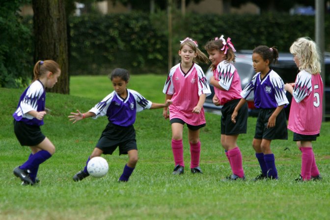 Evangeline, Kelsey, and Sara with three puppies