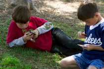 The boys play cards while they wait for their sisters' game to start