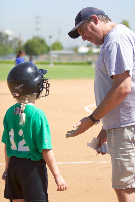 Sara gets some coaching before her at-bat