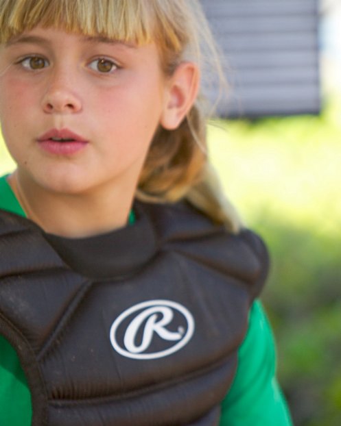 Jennifer putting on her catcher's equipment