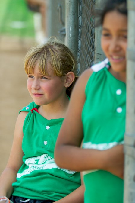 Jennifer and Ashley watch from the dugout door