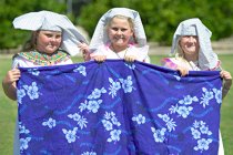 Blanket makers Sára, Lee, and Sara show off their craft