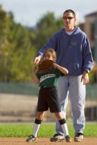 Coach Bill adjusts the fielders' positions