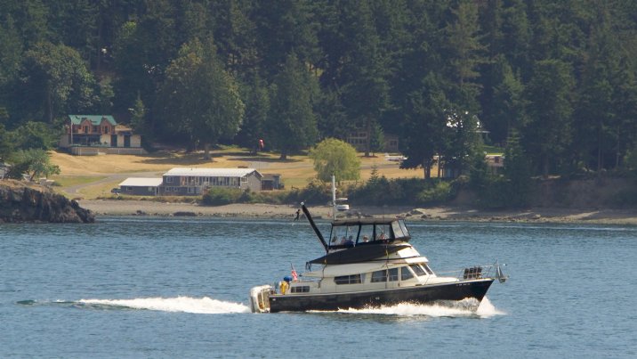 Another boat cruises past the airstrip on nearby Blakely Island