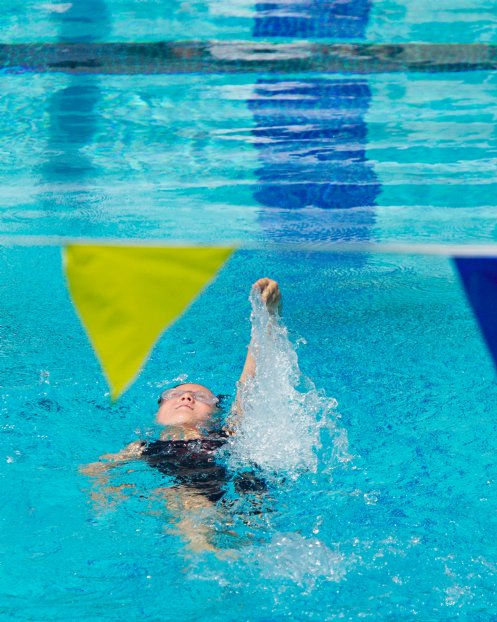 Sara backstroking under the pennants