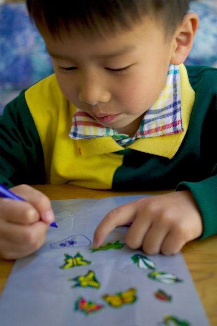 Daniel decorates his bug bag