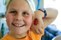 Lee shows off her ladybug tattoo