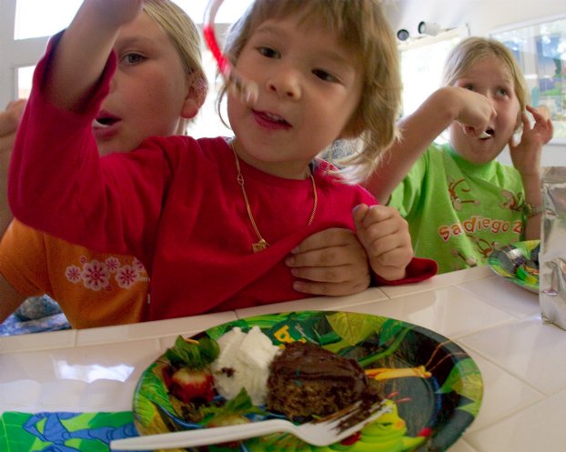 Nico eats a gummy worm from his cake