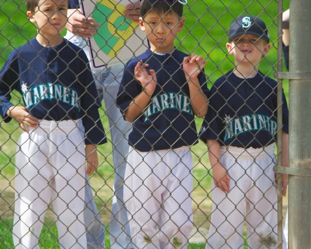 Isaiah, Brian, and Jacob wait for their turns at bat