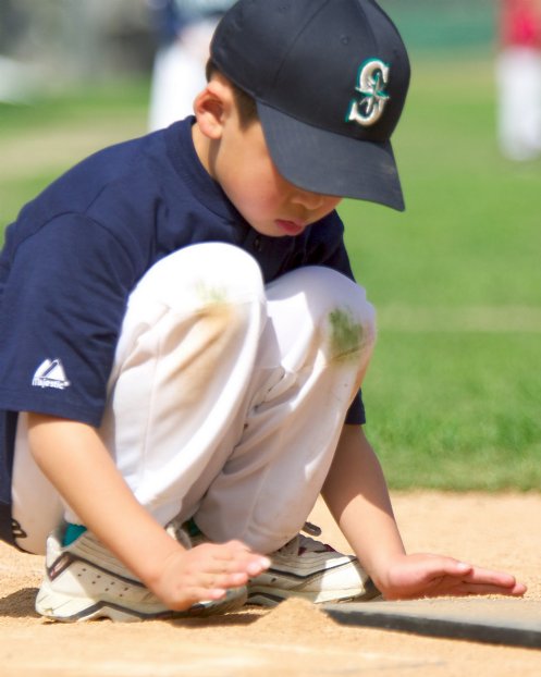 Brian cleans up the plate before batting