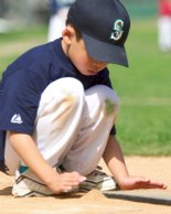 Brian cleans up the plate before batting