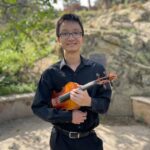Joseph Wong holding a violin