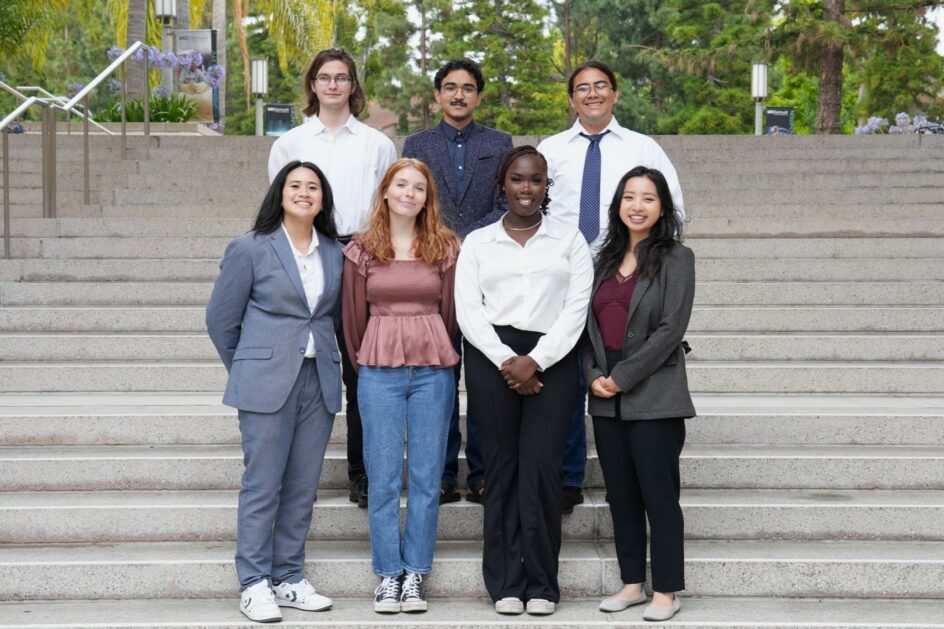 Seven students standing on stairs outside at UCI
