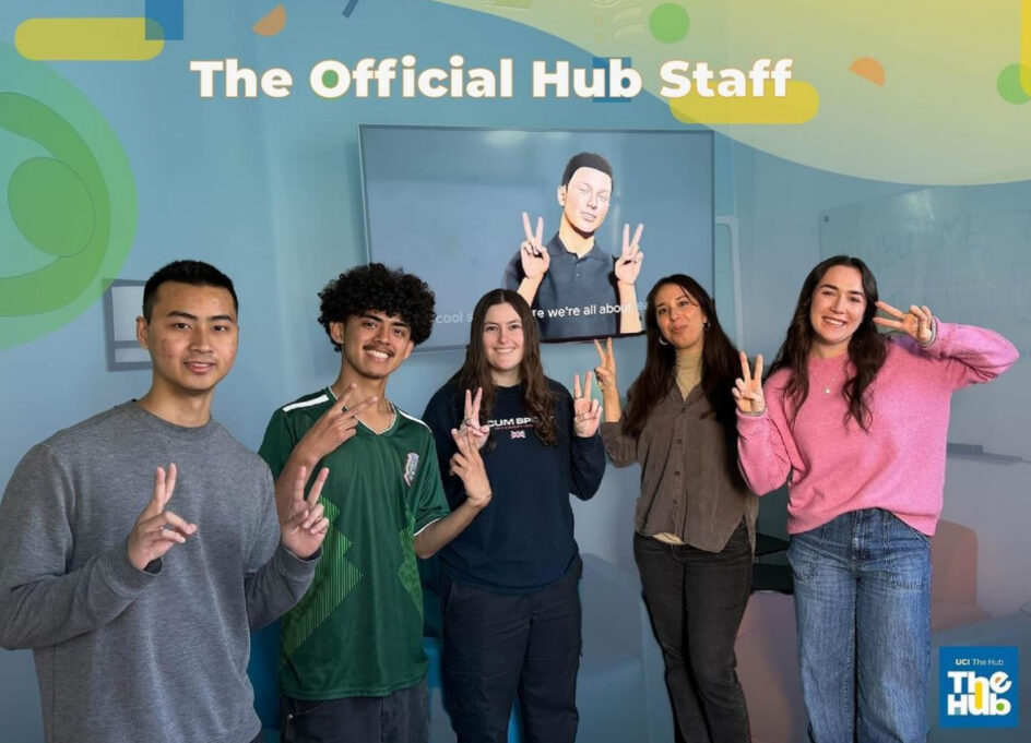 Haley Marts with four other students and the Tommy digital human on a screen behind them. Across the top reads "The Official Hub Staff."