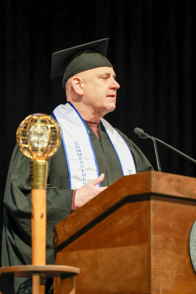 Pat at the podium, speaking during commencement