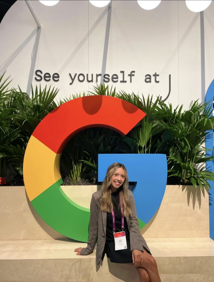 Lidia sits in front of an oversized G - the Google logo