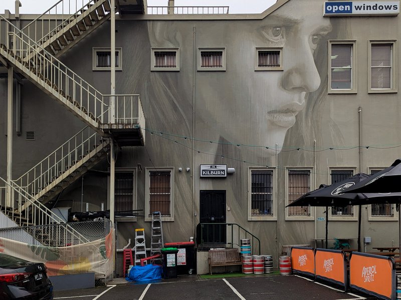 Gray-on-gray woman's profile, street art on The Kilburn, Hawthorn, Victoria, Australia